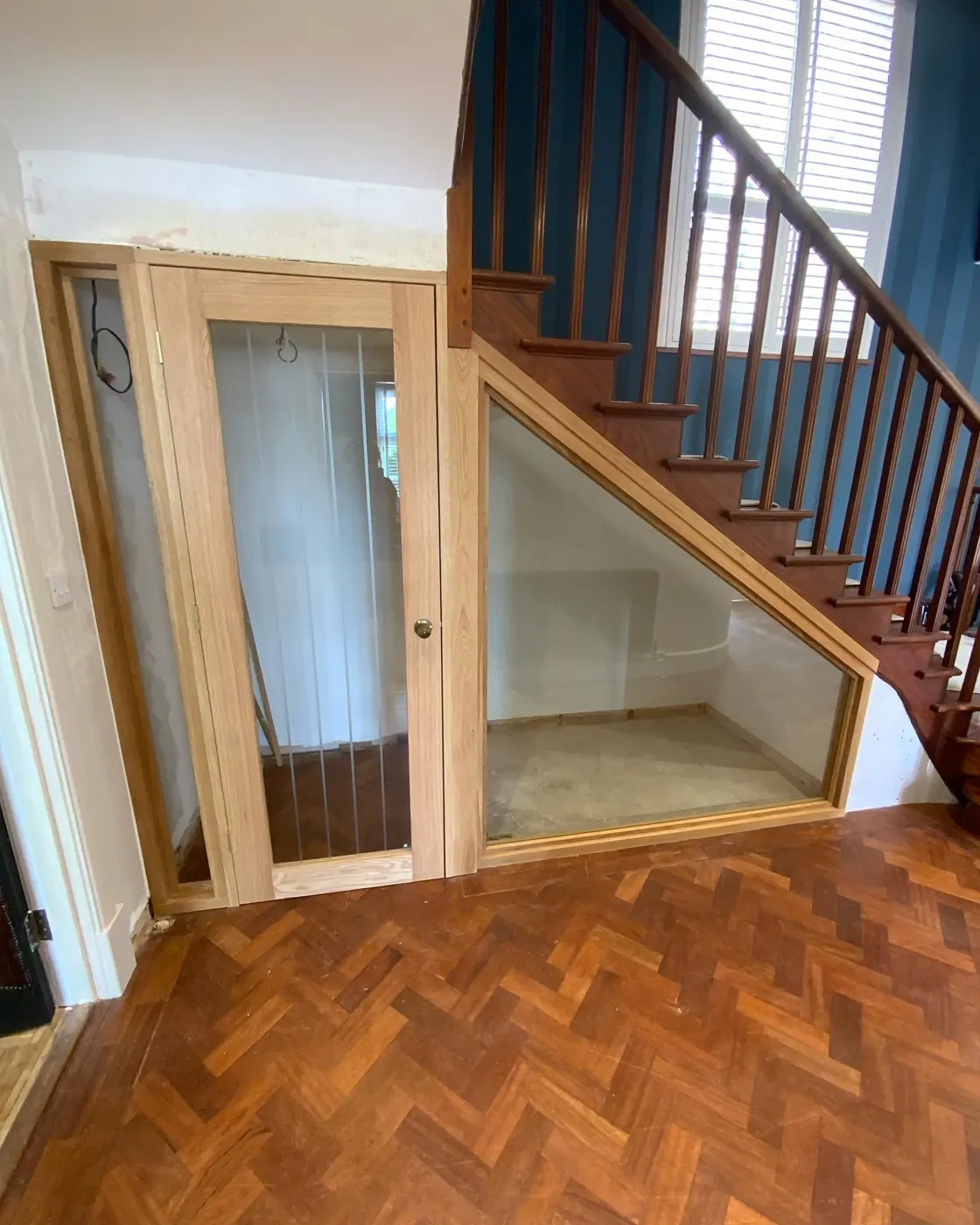 Oak and glass wine store under a staircase